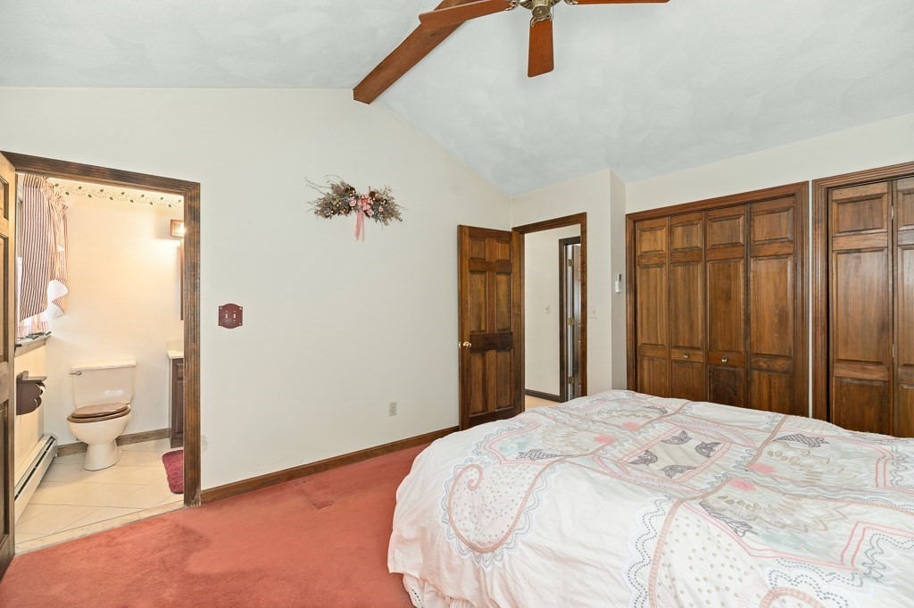 14 Grove Street Danvers, MA 01923 - Photo 14 of 23 a bedroom with a large bed and a chandelier