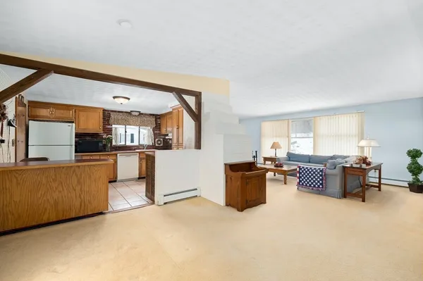 a living room with furniture and kitchen