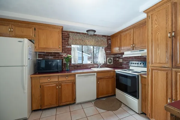 a kitchen with stainless steel appliances granite countertop a refrigerator sink and cabinets