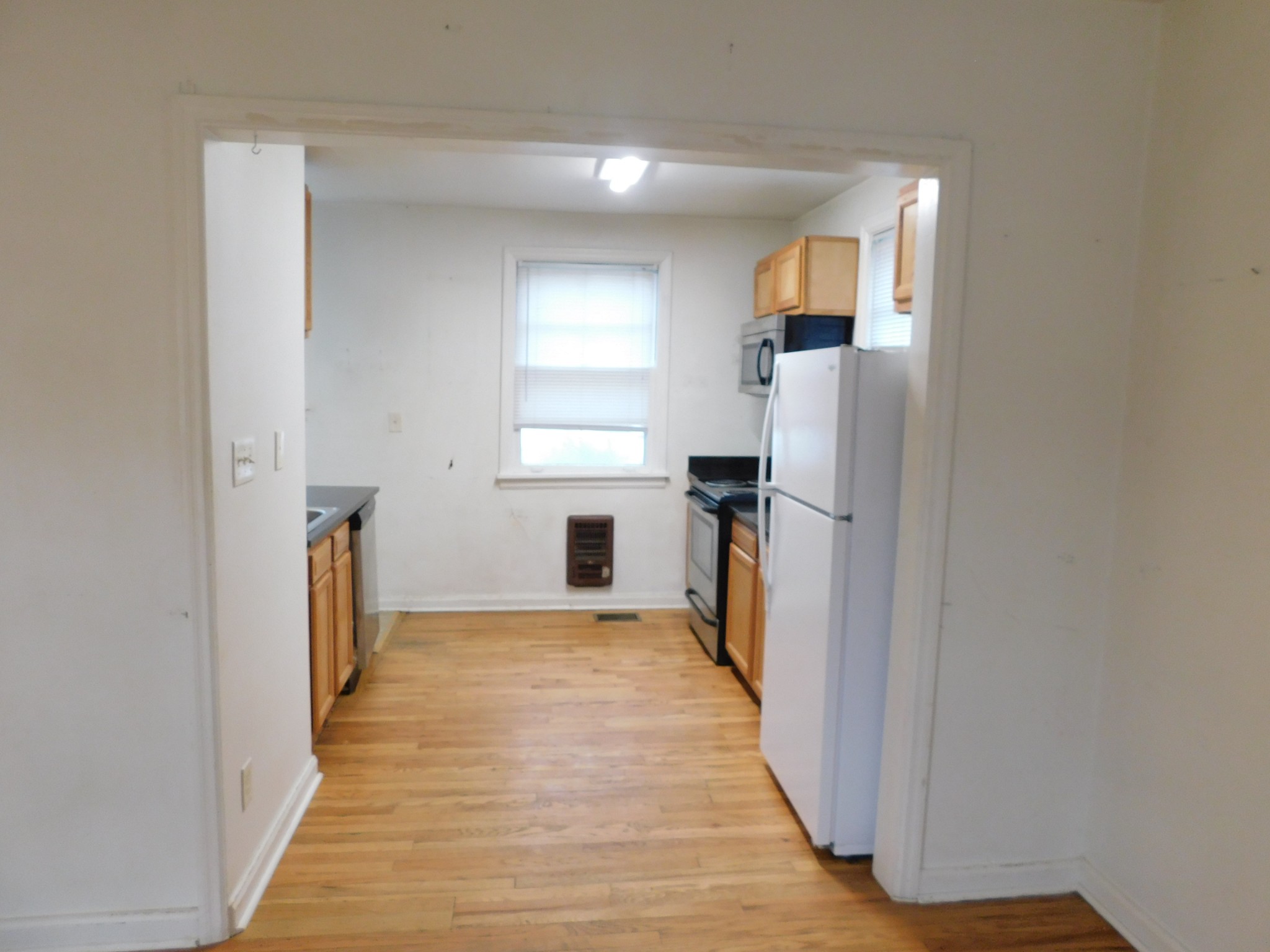 2801 Surrey Road Nashville, TN 37214 - Photo 8 of 43 a view of a kitchen from the hallway with a window and wooden floor