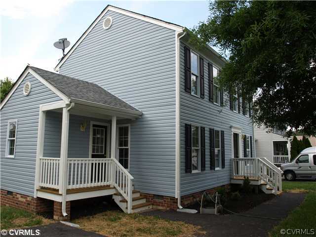 a view of a house with a yard and wooden fence