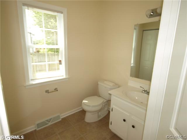 7643 Drexelbrook Road Chesterfield, VA 23832 - Photo 8 of 9 a bathroom with a toilet sink and a window