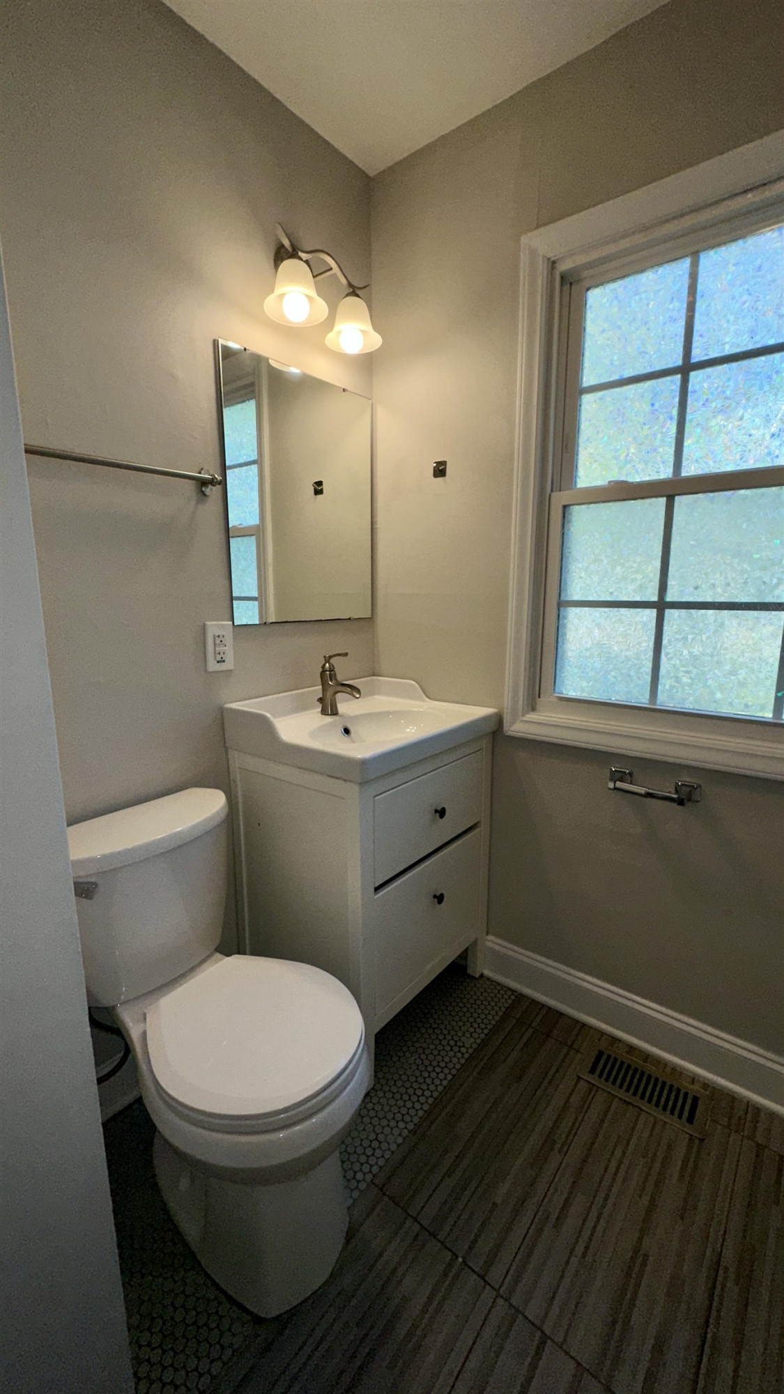1113 Marlborough Road Raleigh, NC 27610 - Photo 12 of 28 a bathroom with a toilet sink and mirror