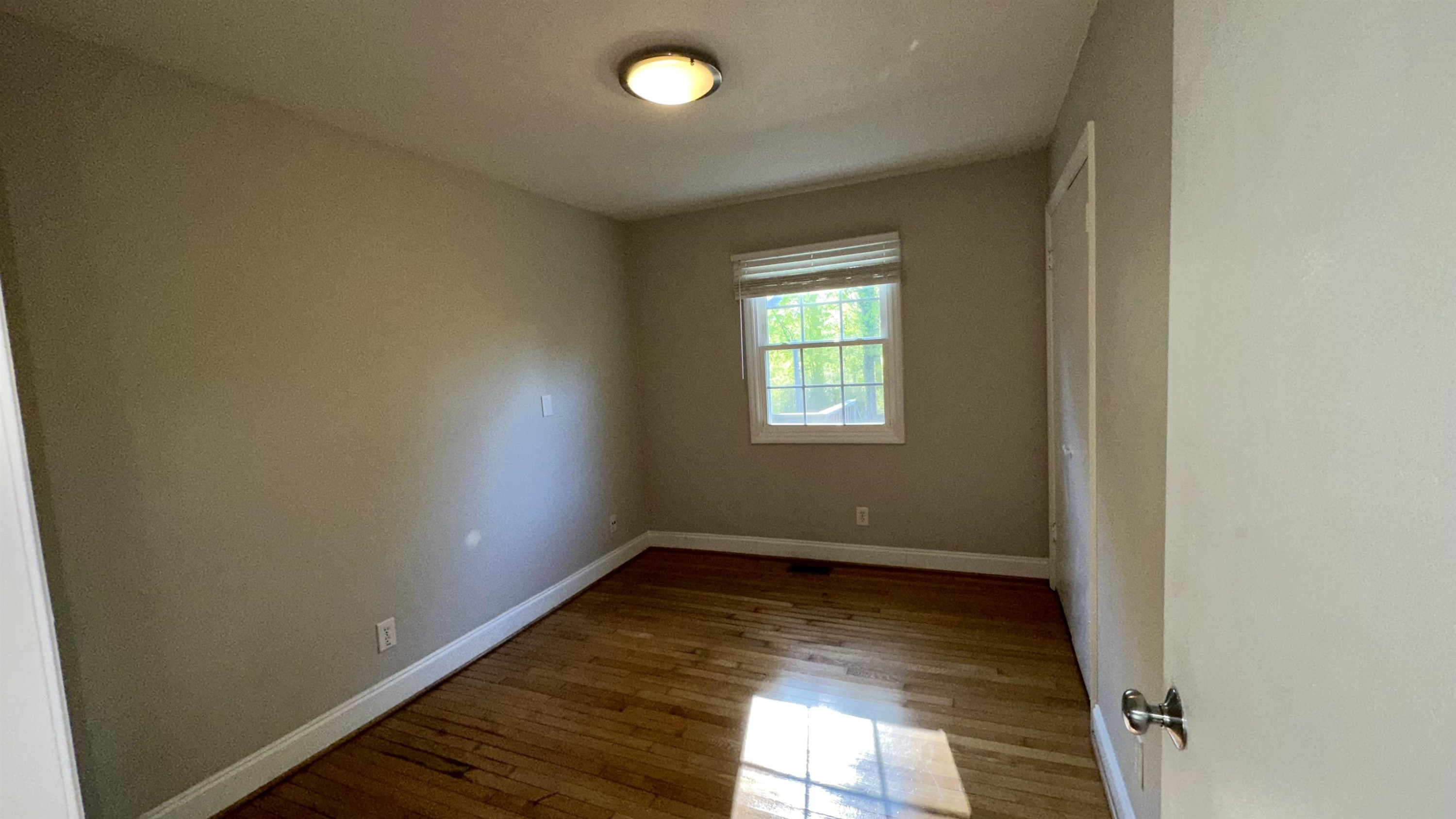 1113 Marlborough Road Raleigh, NC 27610 - Photo 15 of 28 an empty room with wooden floor and windows