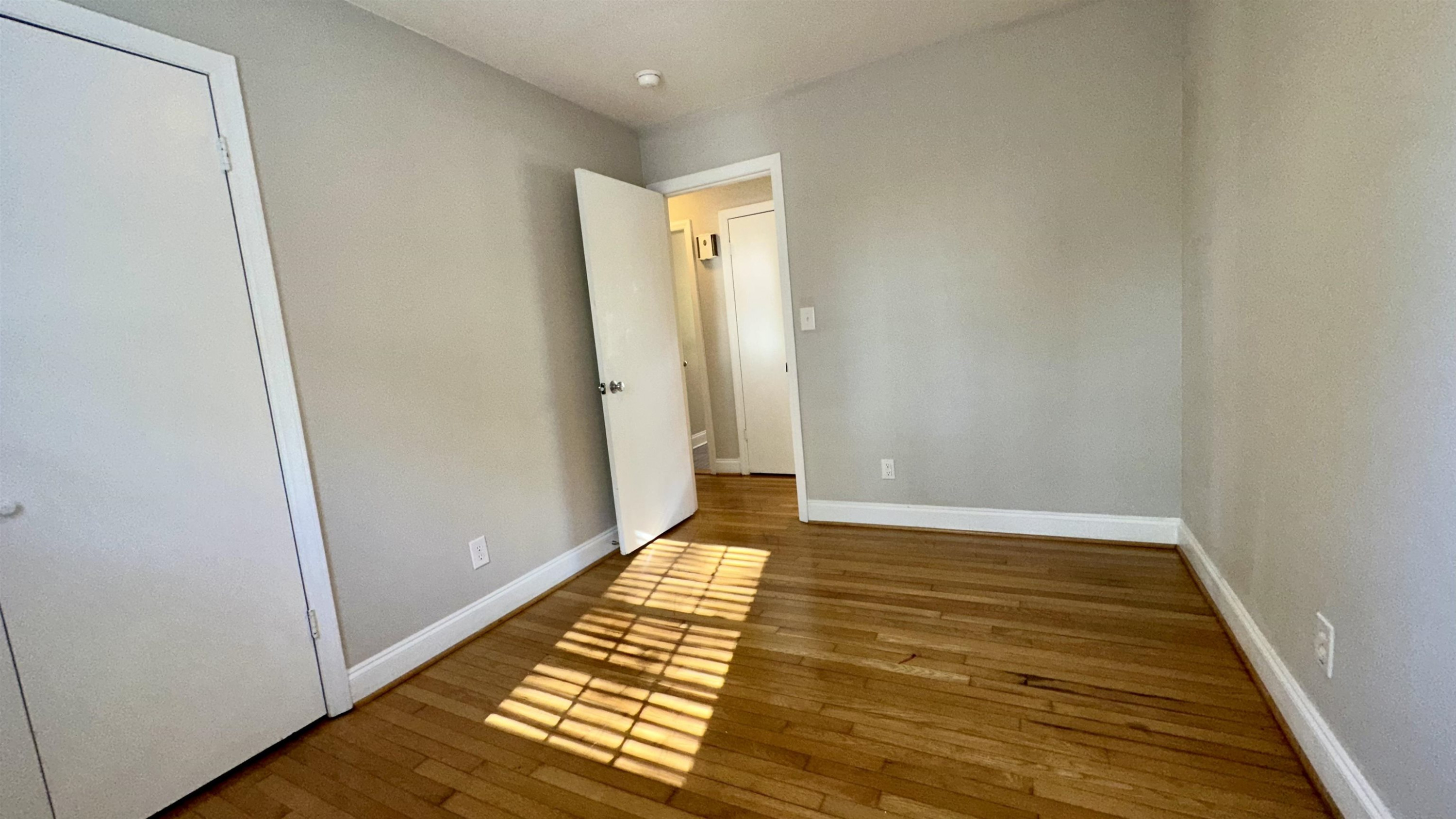 1113 Marlborough Road Raleigh, NC 27610 - Photo 16 of 28 a view of room with window and wooden floor