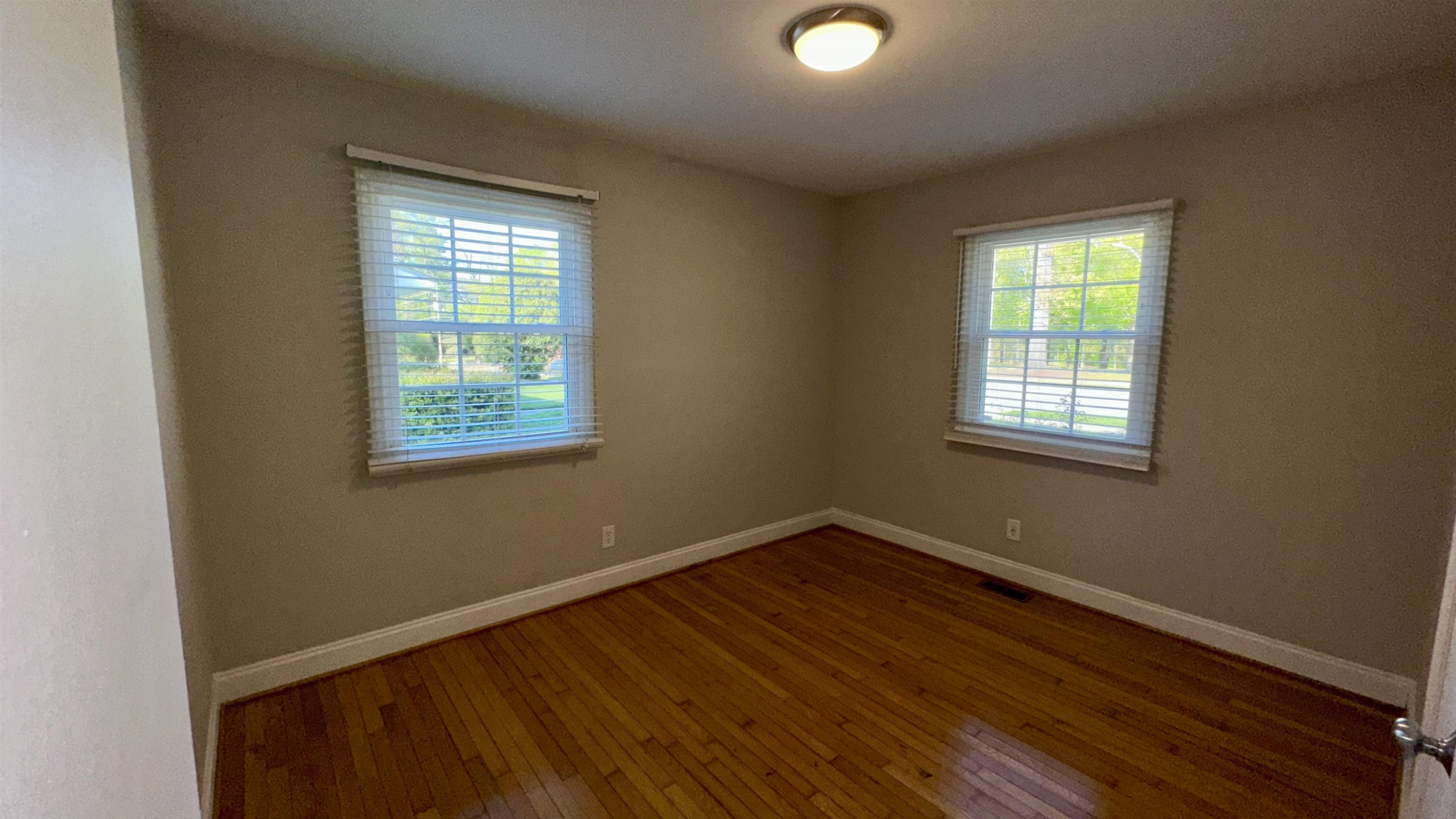 1113 Marlborough Road Raleigh, NC 27610 - Photo 18 of 28 a view of a room with wooden floor and windows