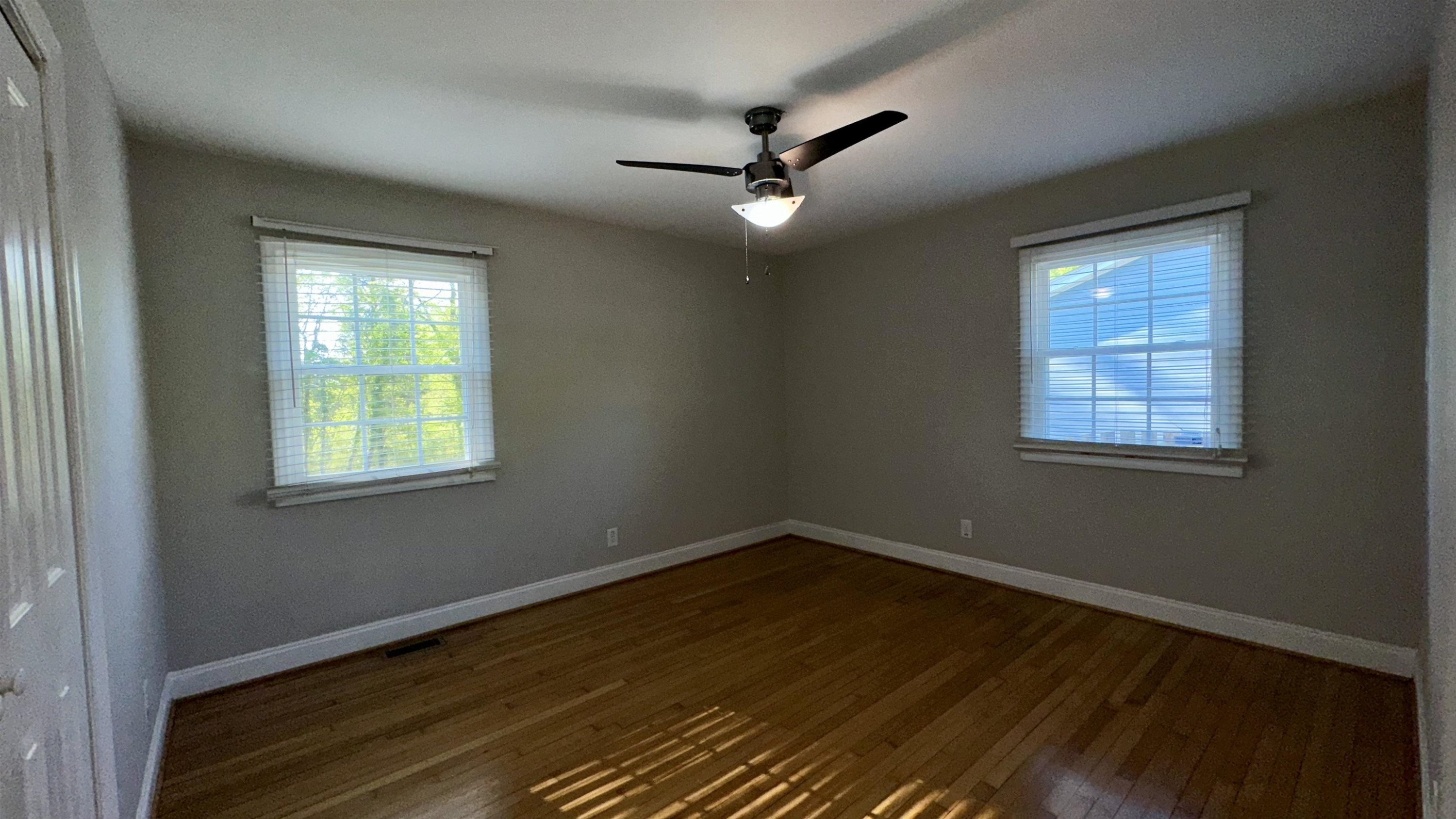 1113 Marlborough Road Raleigh, NC 27610 - Photo 19 of 28 a view of an empty room with wooden floor and a window