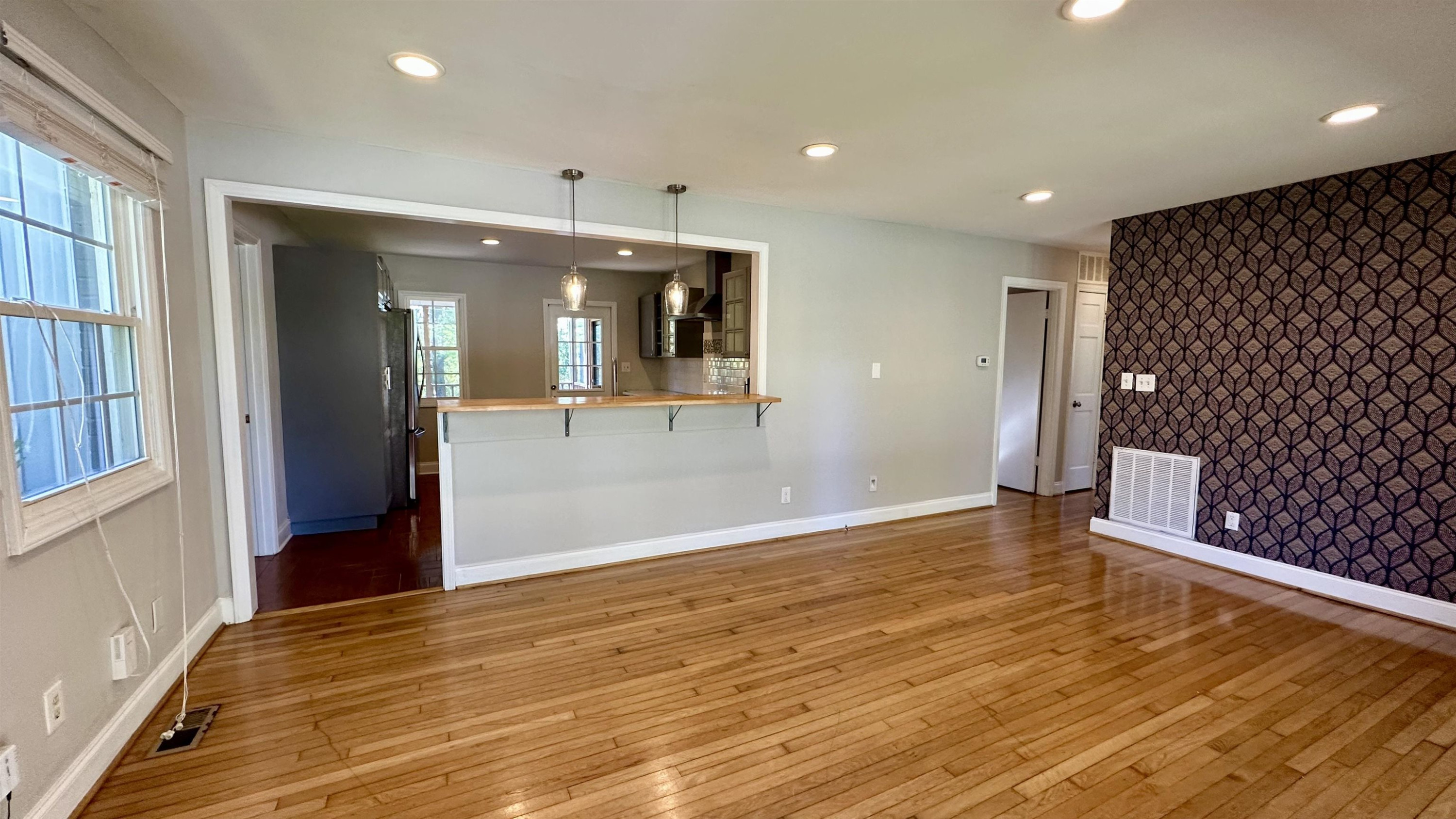 1113 Marlborough Road Raleigh, NC 27610 - Photo 3 of 28 wooden floor in an empty room with a window