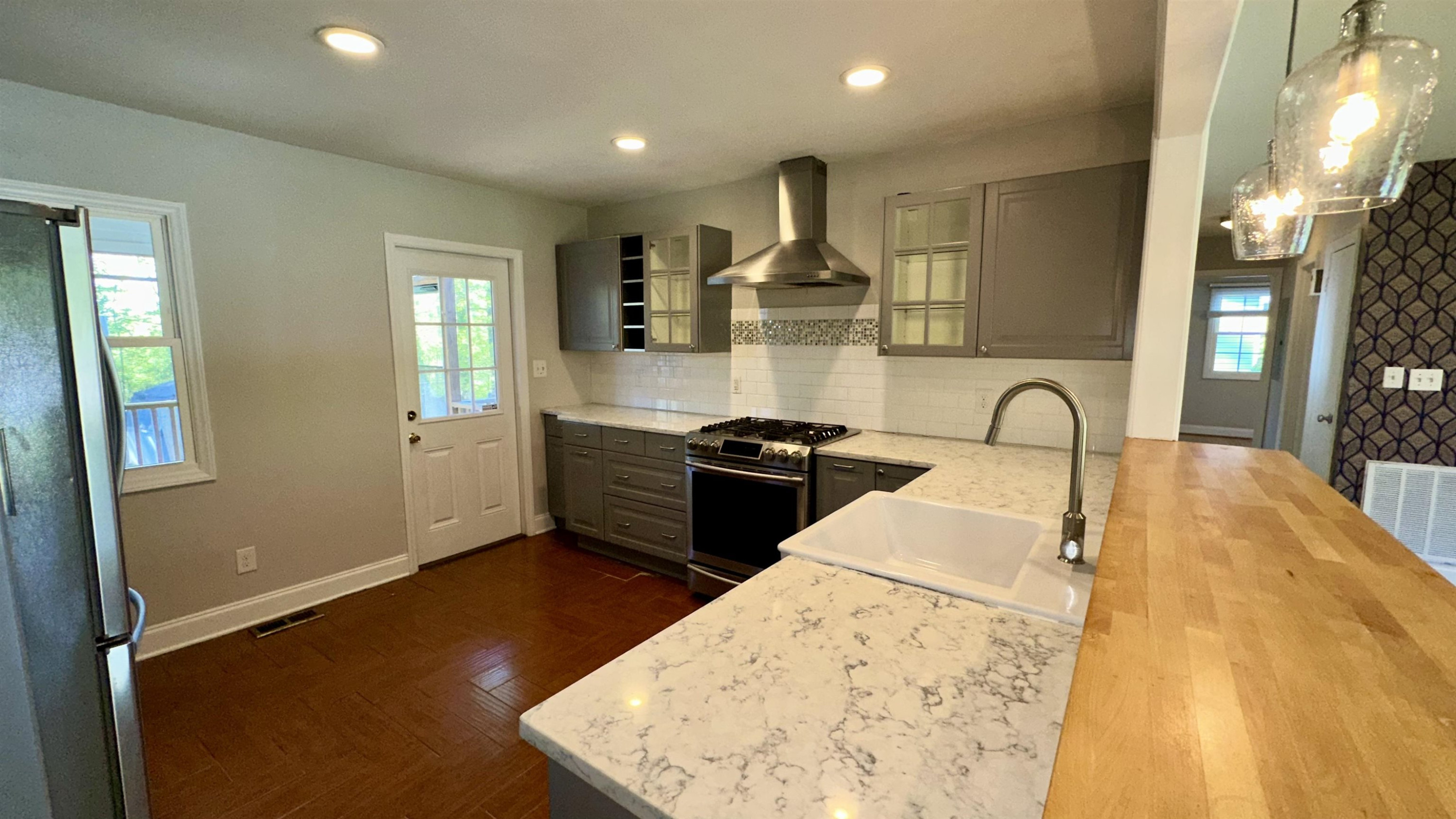 1113 Marlborough Road Raleigh, NC 27610 - Photo 5 of 28 a kitchen with stainless steel appliances kitchen island a stove a sink a refrigerator and a microwave