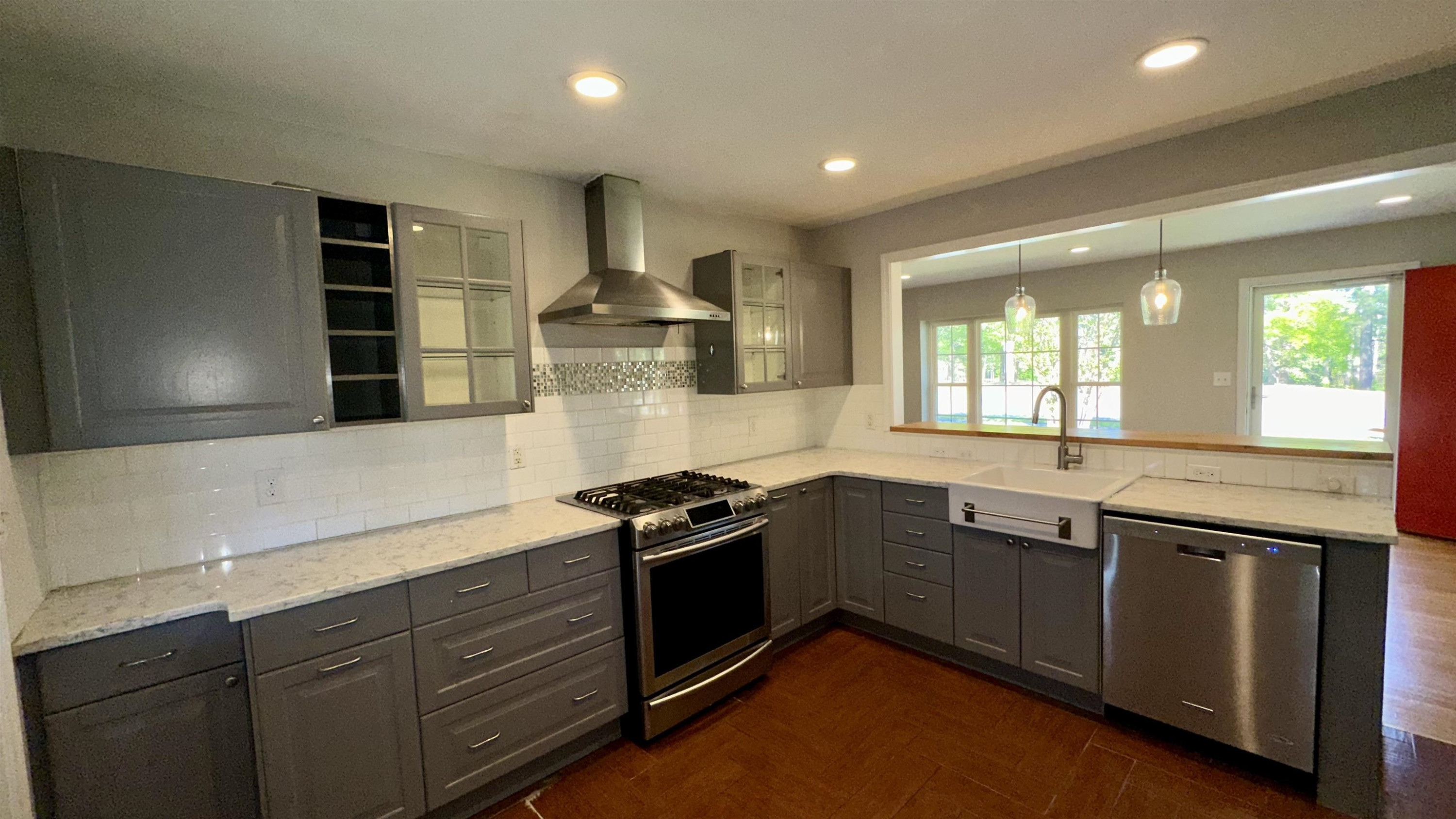 1113 Marlborough Road Raleigh, NC 27610 - Photo 7 of 28 a kitchen with granite countertop stainless steel appliances a sink stove and cabinets