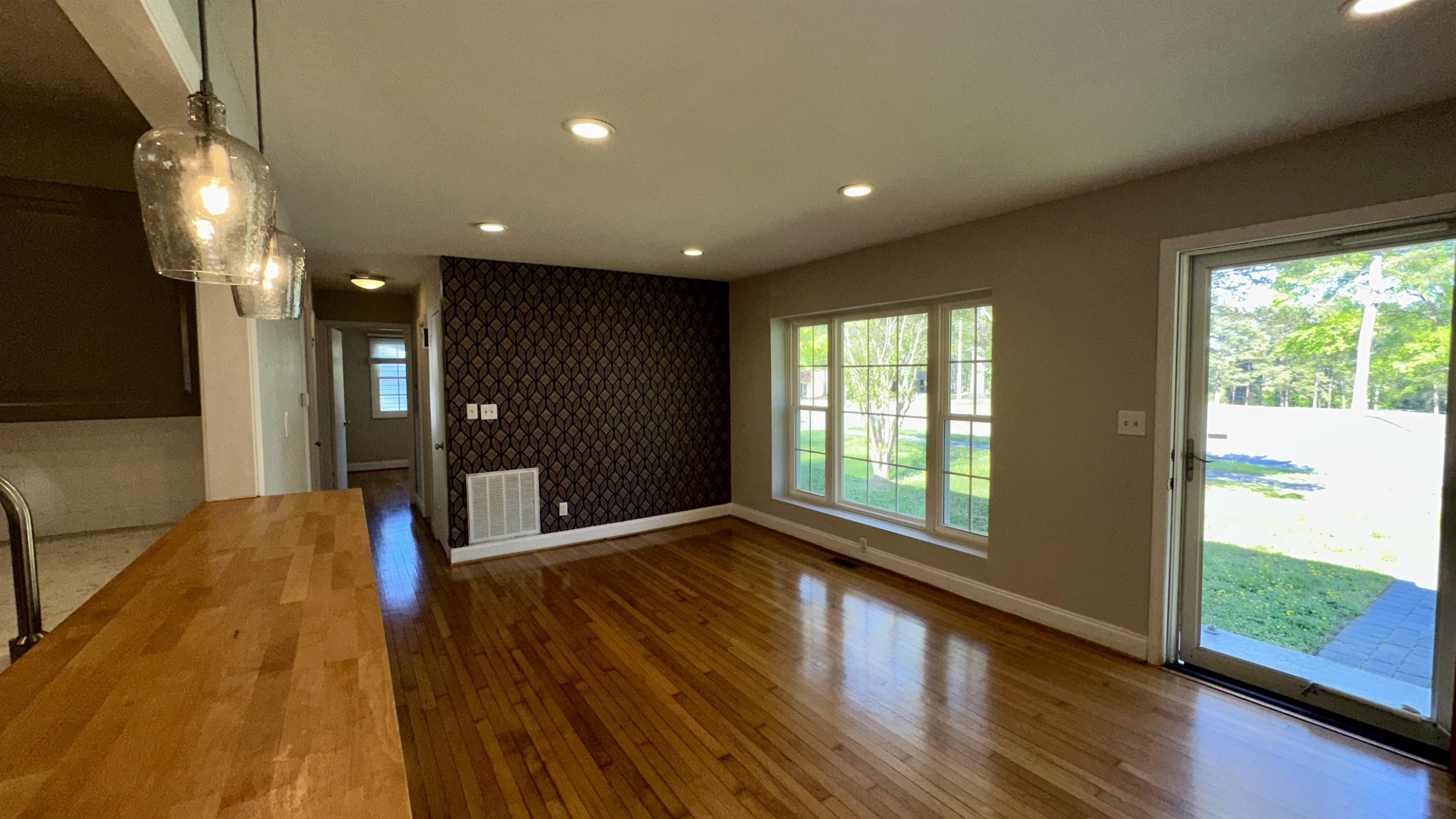 1113 Marlborough Road Raleigh, NC 27610 - Photo 9 of 28 a view of hallway with a large window and wooden floor