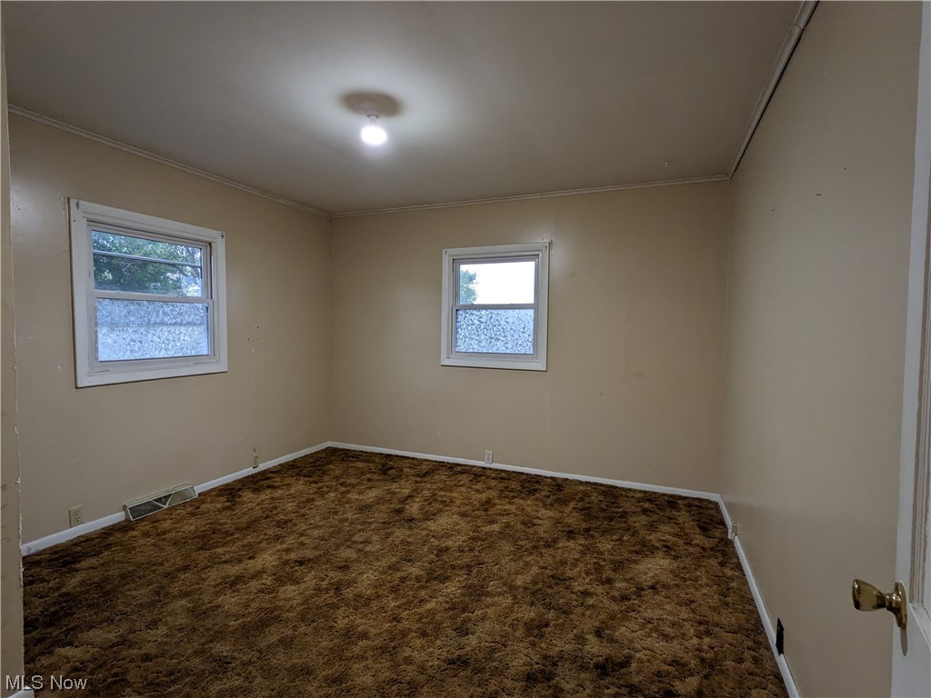 38 Frederick Street Rittman, OH 44270 - Photo 10 of 13 Unfurnished bedroom with crown molding and carpet floors