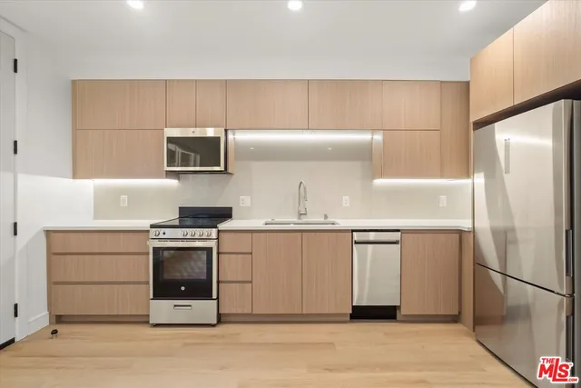 a kitchen with a refrigerator sink and stove