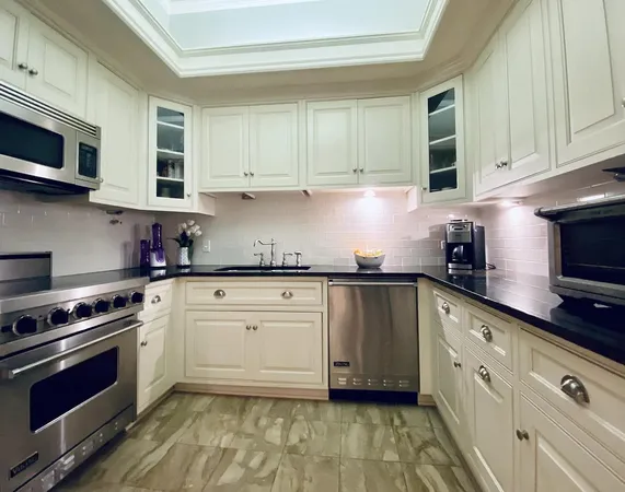 a kitchen with stainless steel appliances granite countertop a sink stove and microwave