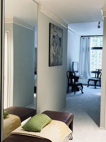 a bedroom with a bed and glass windows