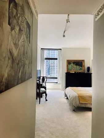a bedroom with a bed and a couch