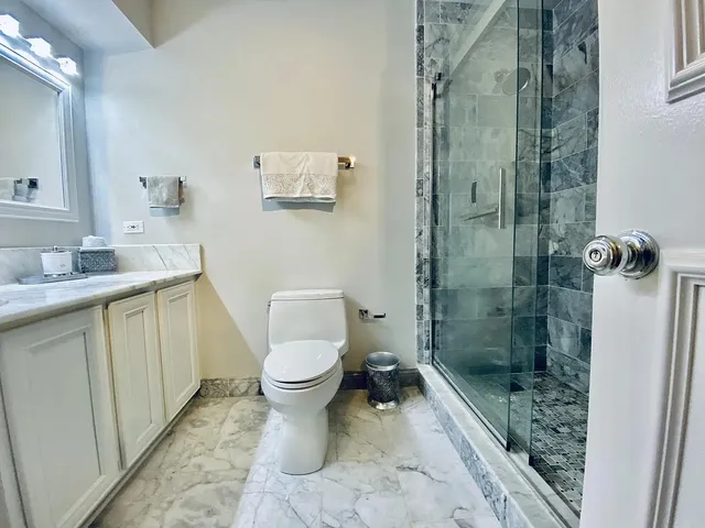 a bathroom with a sink toilet and shower
