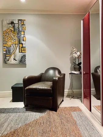 a living room with furniture and a lamp