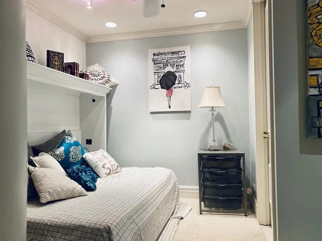 a bedroom with a bed and cabinets