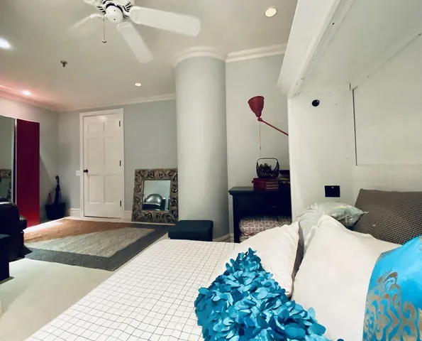 a bedroom with a bed and a chandelier