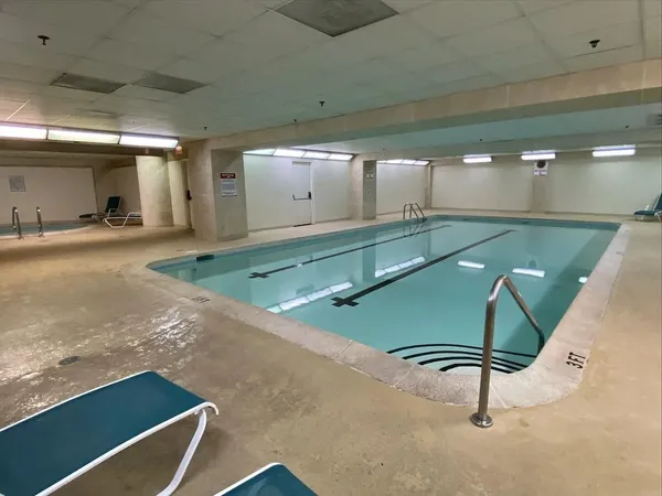a room with pool table and windows