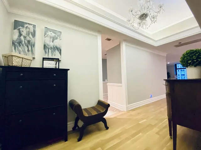 a living room with furniture and paintings on the wall