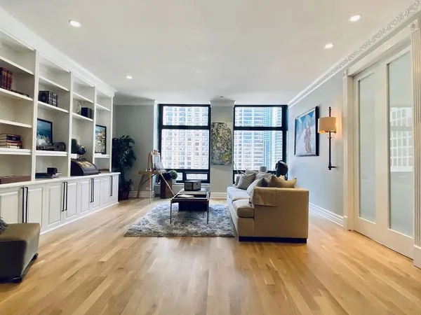 a living room with furniture window and wooden floor