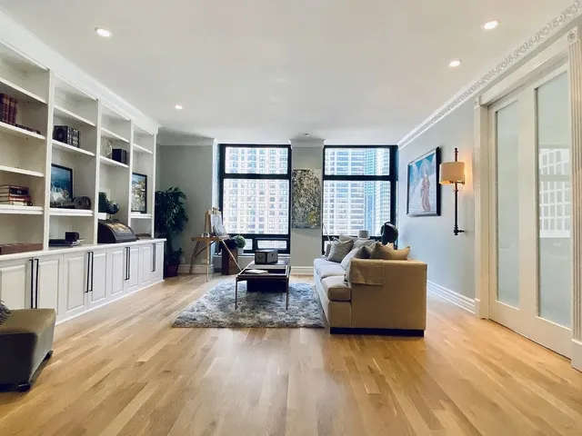 a living room with furniture window and wooden floor