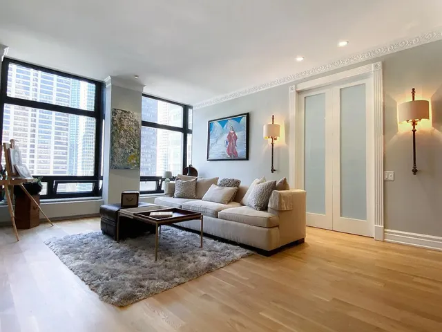 a living room with furniture window and wooden floor