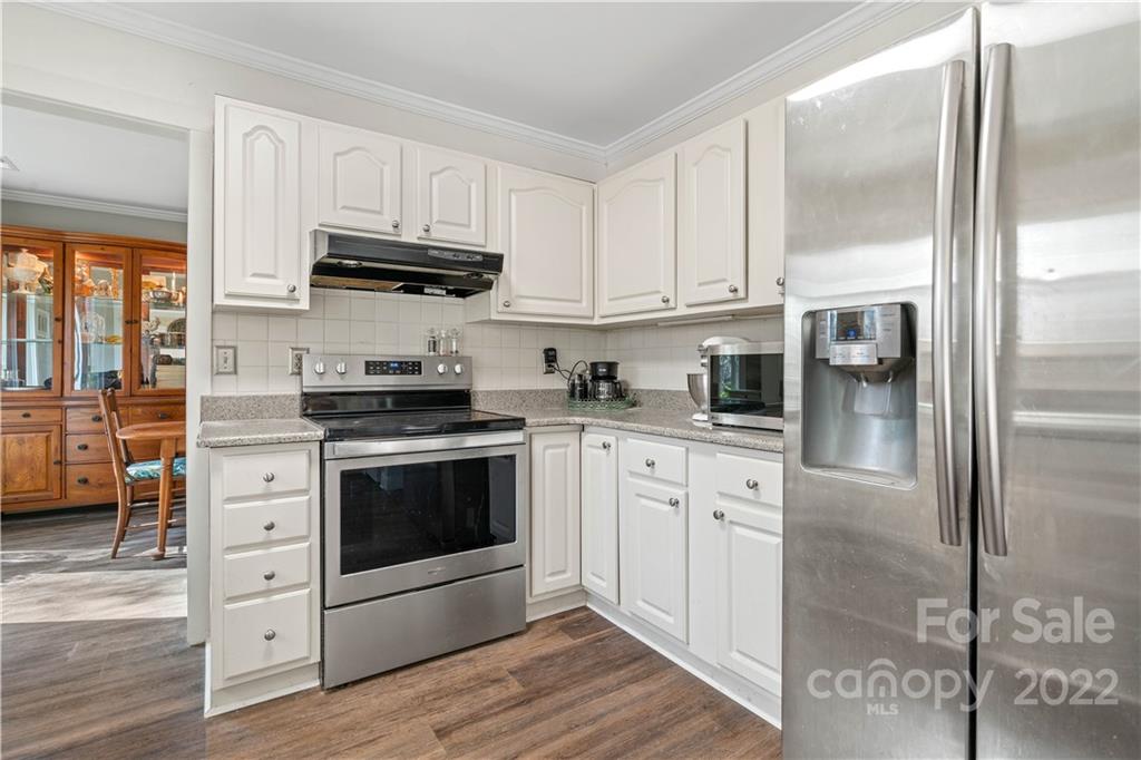 9907 Fairway Ridge Road Charlotte, NC 28277 - Photo 12 of 37 a kitchen with stainless steel appliances granite countertop a stove a refrigerator and a microwave