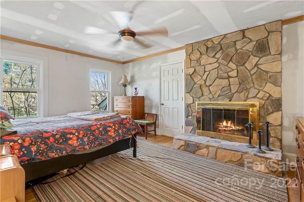 9907 Fairway Ridge Road Charlotte, NC 28277 - Photo 23 of 37 a bedroom with a bed and a fireplace