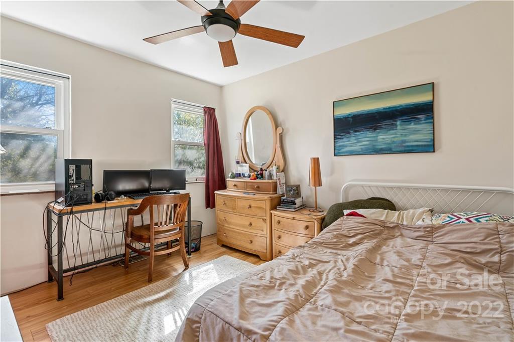 9907 Fairway Ridge Road Charlotte, NC 28277 - Photo 26 of 37 a bedroom with a bed and a chandelier