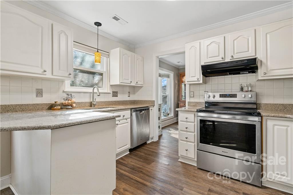 9907 Fairway Ridge Road Charlotte, NC 28277 - Photo 8 of 37 a kitchen with stainless steel appliances granite countertop a stove a sink and a microwave