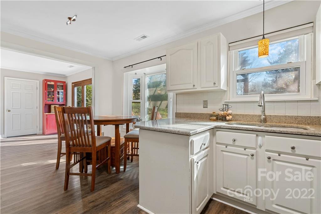 9907 Fairway Ridge Road Charlotte, NC 28277 - Photo 10 of 37 a kitchen with granite countertop white cabinets and dining table