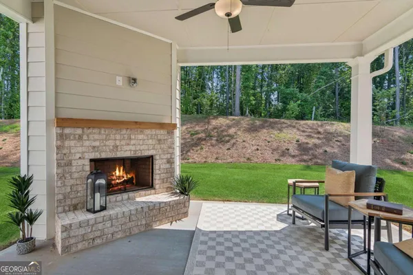 a living room with a fireplace and a garden