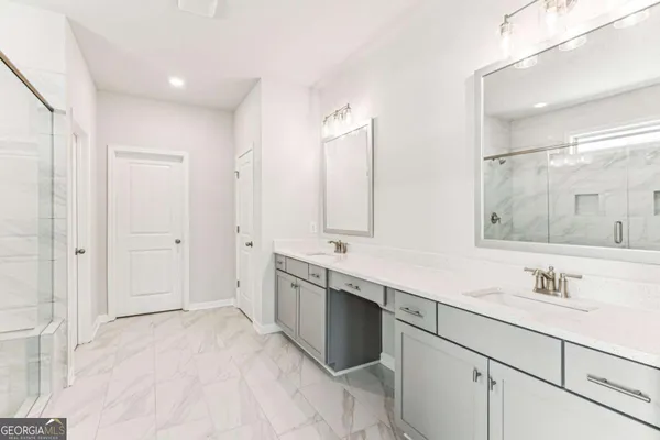 a spacious bathroom with a double vanity sink mirror and double