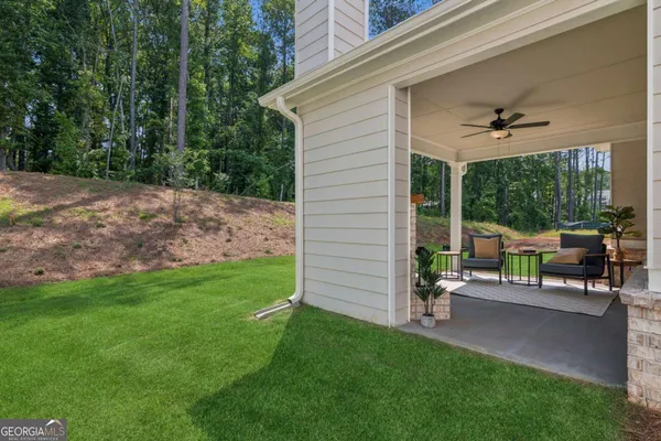 a view of a patio with a table chairs and a backyard