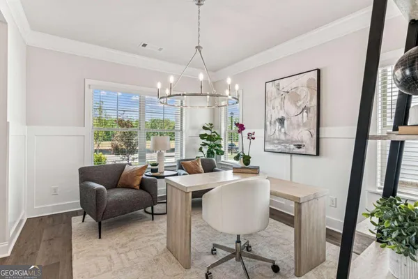 a dining room with furniture a chandelier and window