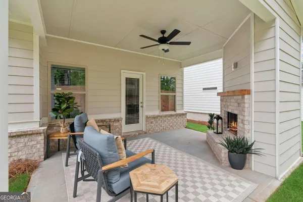 a view of a house with backyard and sitting area