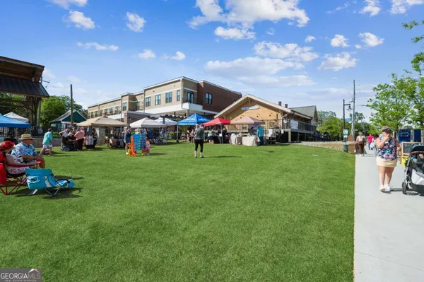 a view of a house with a big yard and sitting area