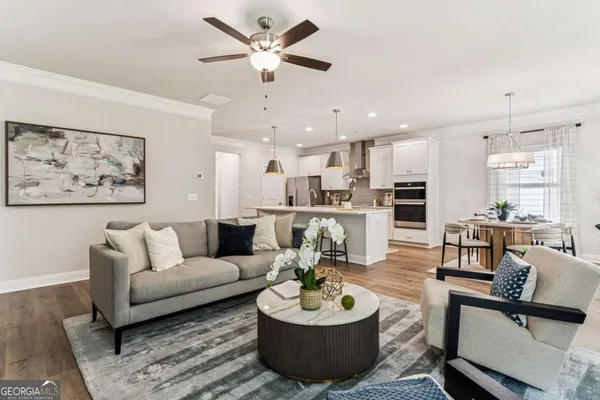 a living room with furniture kitchen and a kitchen view