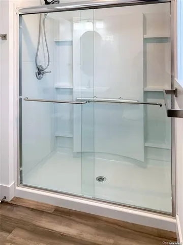 a bathroom with a glass shower door