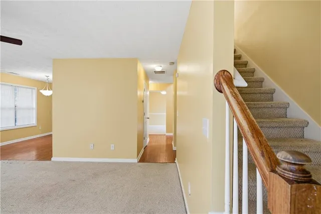 a view of an empty room with a window and fireplace
