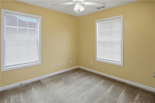 a view of a livingroom with wooden floor fireplace and windows