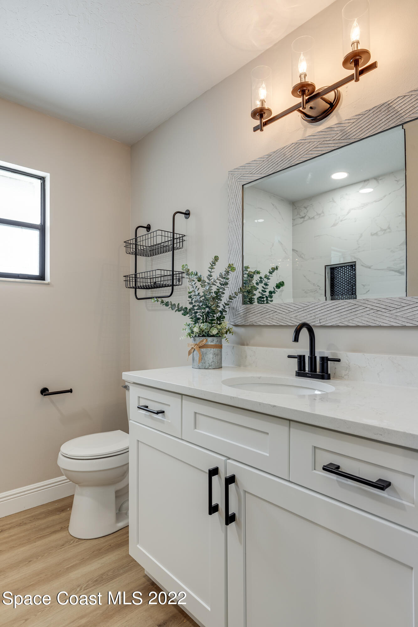 1011 Thompson Road Southwest Palm Bay, FL 32908 - Photo 11 of 17 a bathroom with a sink a toilet and mirror