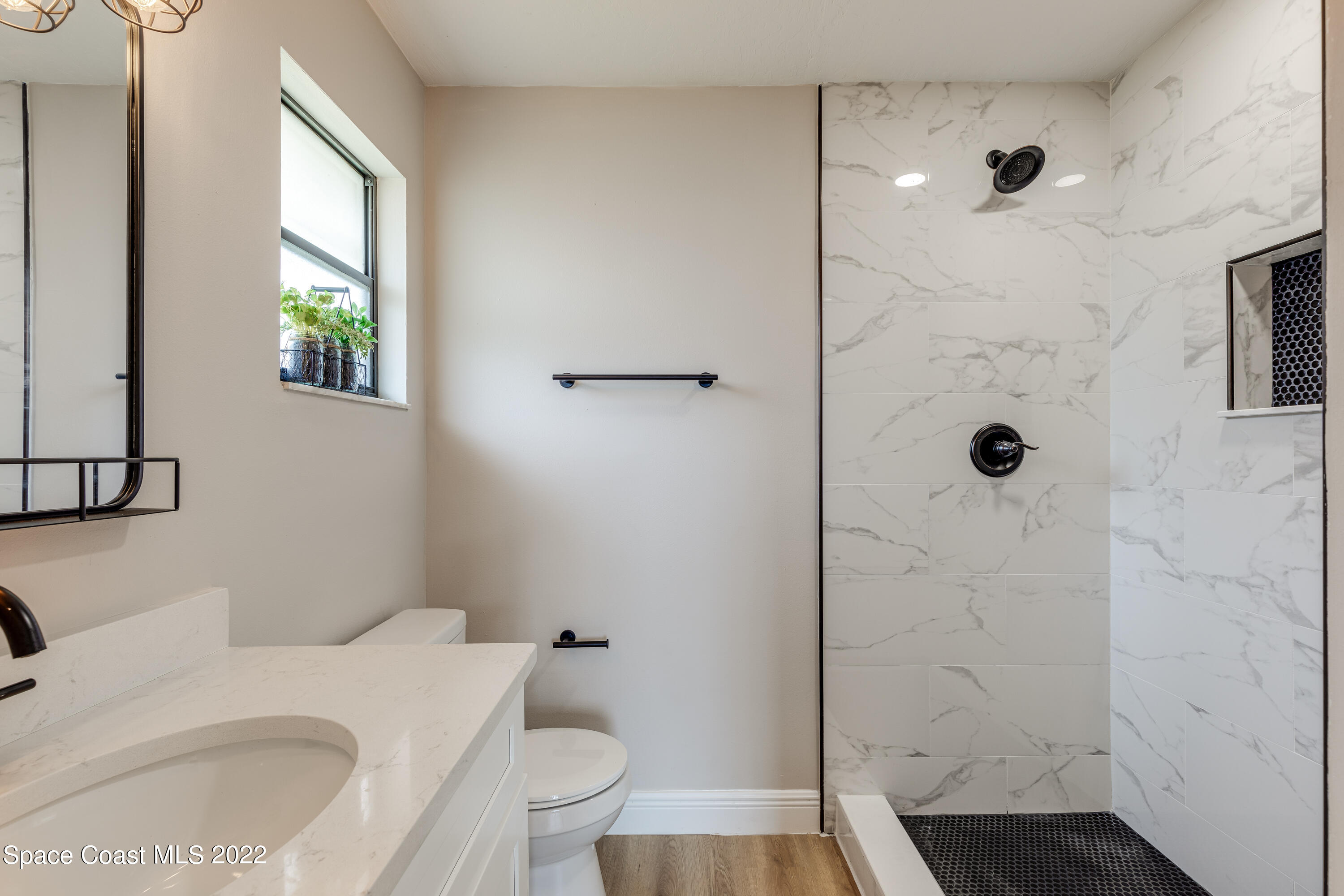 1011 Thompson Road Southwest Palm Bay, FL 32908 - Photo 13 of 17 a bathroom with a sink and toilet