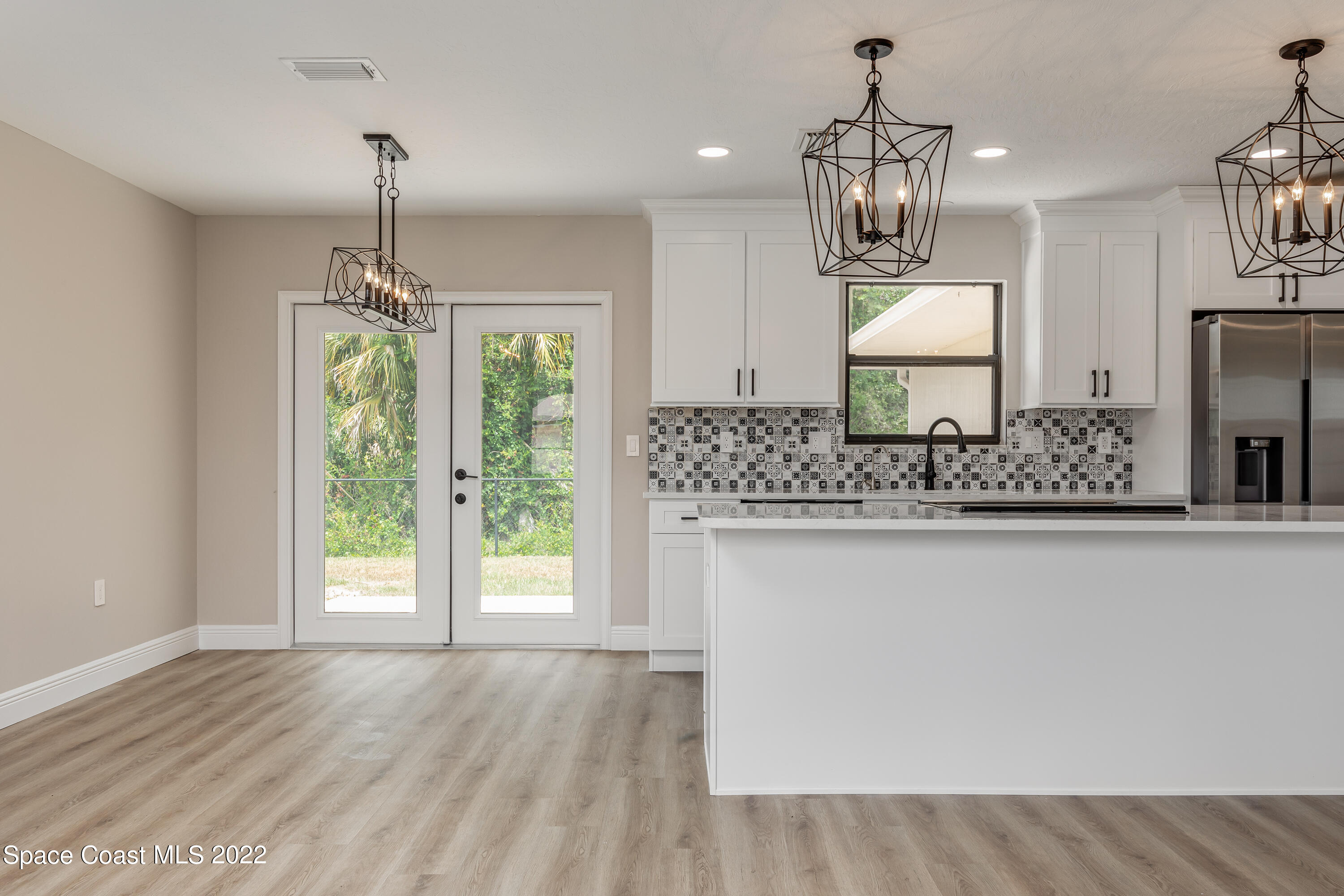 1011 Thompson Road Southwest Palm Bay, FL 32908 - Photo 6 of 17 a view of counter top space and chandelier