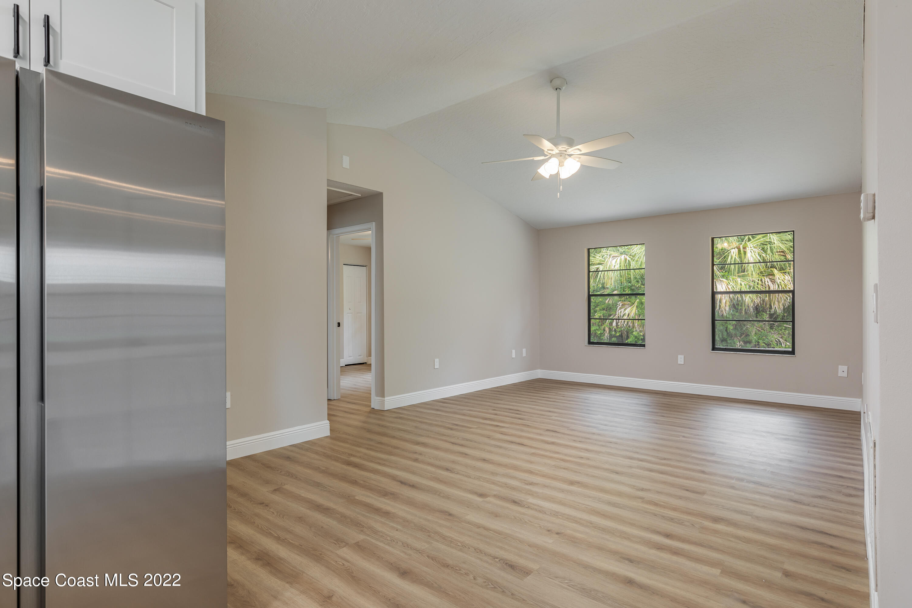 1011 Thompson Road Southwest Palm Bay, FL 32908 - Photo 10 of 17 a view of an empty room with wooden floor and a window