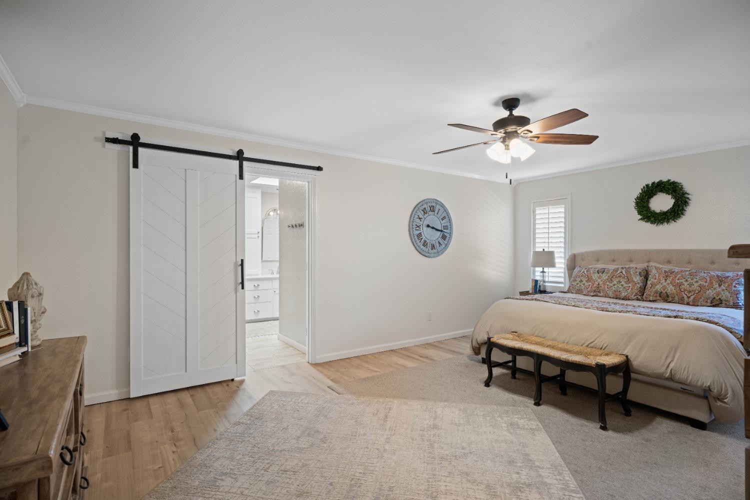 5409 88th Street Lubbock, TX 79424 - Photo 13 of 23 a spacious bedroom with a bed and a chandelier