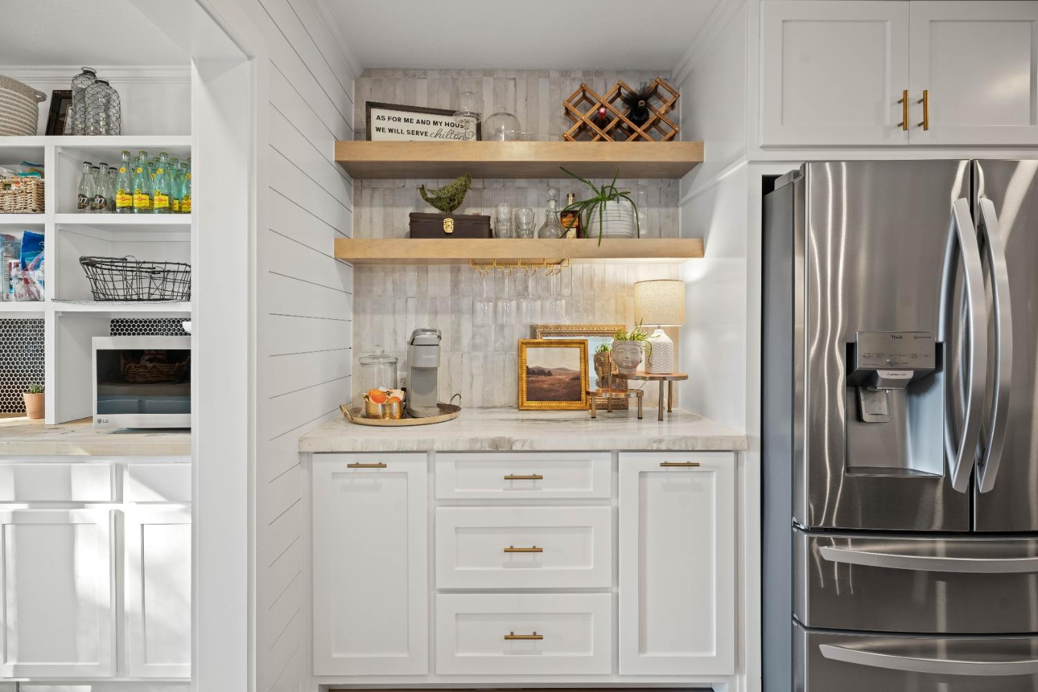5409 88th Street Lubbock, TX 79424 - Photo 9 of 23 a kitchen with white cabinets and refrigerator